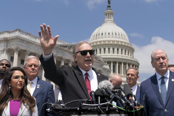 Rep. Andy Biggs, R-Ariz., center, speaks with other lawmakers in the conservative House Freedom Caucus at a news conference to voice their objections to the debt limit deal reached by Speaker of the House Kevin McCarthy, R-Calif., and President Joe Biden, at the Capitol in Washington, Tuesday, May 30, 2023. (AP Photo/J. Scott Applewhite)