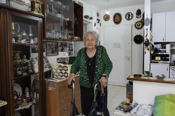 Holocaust survivor Tova Gutstein, 90, who lived in the Warsaw Ghetto as a child, poses for a photo at her apartment in the city of Rishon Lezion, Israel, Sunday, April 9, 2023. Gutstein was a child when the Nazis put down the Warsaw Ghetto Uprising. Now 90, she is one of the few remaining survivors who witnessed that act of Jewish resistance against Nazi Germany as Israel marks the revolt's 80th anniversary on Holocaust Memorial Day. (AP Photo/Tsafrir Abayov)