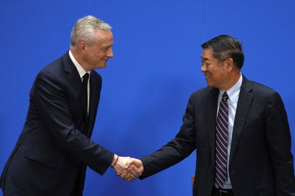 French Finance Minister Bruno Le Maire, left and Chinese Vice Premier He Lifeng shake hands after a joint press conference at the end of the 9th China-France High Level Economic and Financial Dialogue held at the Diaoyutai State Guest House in Beijing, Saturday, July 29, 2023. (AP Photo/Ng Han Guan)