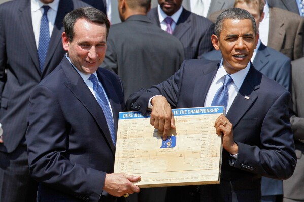 In this May 27, 2010 file photo, President Barack Obama looks over the bracket with Duke University basketball Coach Mike Krzyzewski in the Rose Garden of the White House in Washington, where he honored the team. (AP Photo/Alex Brandon, File)