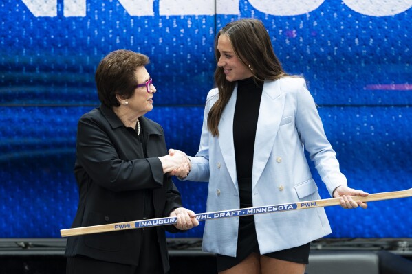 CORRECTS TO TAYLOR HEISE NOT TAYLER HEISE - Taylor Heise, right, shakes hands with tennis legend Billie Jean King after being selected first overall by Minnesota in the inaugural Professional Women's Hockey League draft in Toronto, Monday, Sept. 18, 2023. (Spencer Colby/The Canadian Press via AP)