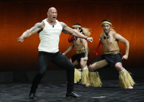 Dwayne "The Rock" Johnson dances onstage before introducing a clip from the upcoming animated film "Moana 2" during the Walt Disney Studios presentation at CinemaCon 2024, at Caesars Palace in Las Vegas, April 11, 2024. (AP Photo/Chris Pizzello)