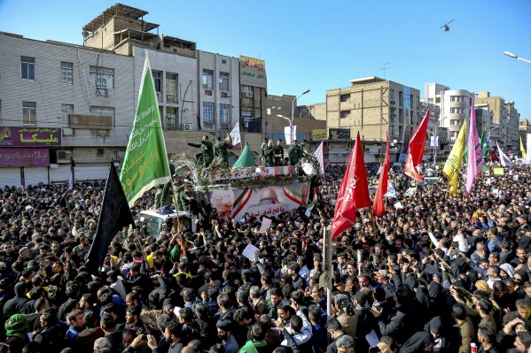 In this photo provided by the Iranian Students' News Agency, ISNA, flag draped coffins of Gen. Qassem Soleimani and his comrades who were killed in Iraq in a U.S. drone strike, carried on a truck surrounded by mourners during their funeral in southwestern city of Ahvaz, Iran, Sunday, Jan. 5, 2020. The body of Soleimani arrived Sunday in Iran to throngs of mourners, as U.S. President Donald Trump threatened to bomb 52 sites in the Islamic Republic if Tehran retaliates by attacking Americans. (Alireza Mohammadi/ISNA via AP)