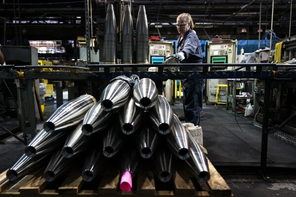 FILE -A steel worker moves a 155 mm M795 artillery projectile during the manufacturing process at the Scranton Army Ammunition Plant in Scranton, Pa., Thursday, April 13, 2023. The Pentagon could get weapons moving to Ukraine within days if Congress passes a long-delayed aid bill. That's because it has a network of storage sites in the U.S. and Europe that already hold the ammunition and air defense components that Kyiv desperately needs. Moving fast is critical, CIA Director Bill Burns said Thursday, April 18, 2024. (AP Photo/Matt Rourke, File)