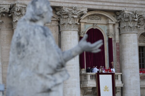 A statue of the Bernini Colonnade frames Pope Leo XIV appearing on the balcony of St Peter's Basilica after his election, at the Vatican, Thursday, May 8, 2025. (AP Photo/Luca Bruno)