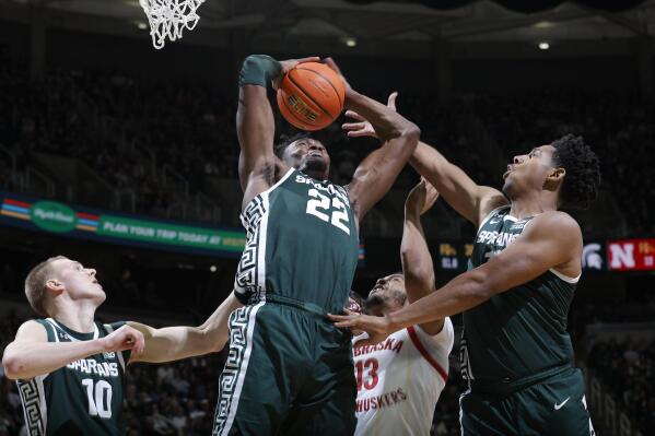 Michigan State's Mady Sissoko (22), Joey Hauser, left, and A.J. Hoggard, right, and Nebraska's Derrick Walker (13) vie for a rebound during the first half of an NCAA college basketball game Tuesday, Jan. 3, 2023, in East Lansing, Mich. (AP Photo/Al Goldis)