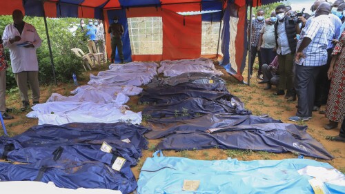 FILE - Body bags are laid out at the scene where dozens of bodies have been found in shallow graves in the village of Shakahola, near the coastal city of Malindi, in southern Kenya on April 24, 2023. The number of people who died in connection with Kenya’s doomsday cult has crossed the 400 mark as detectives exhumed 12 more bodies on Monday, July 18, 2023, believed to be followers of a pastor who ordered them to fast to death in order to meet Jesus. Pastor Paul Mackenzie, who is linked to the cult based in a forested area in Malindi, coastal Kenya, is in police custody, along with 36 other suspects. All have yet to be charged. (AP Photo)