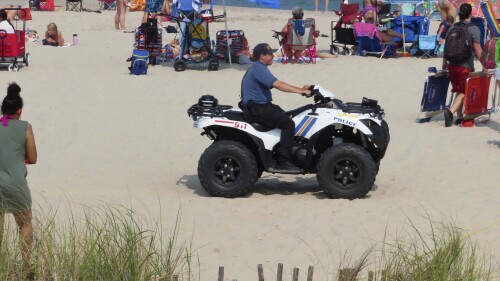 A police officer in a dune vehicle patrols the beach in Seaside Heights, N.J., on Thursday, June 29, 2023. Officials and residents of several New Jersey shore towns say the state’s law decriminalizing marijuana use is having an unintended effect: emboldening large groups of teenagers to run amok on beaches and boardwalks, knowing there is little chance of them getting in trouble for it. (AP Photo/Wayne Parry)