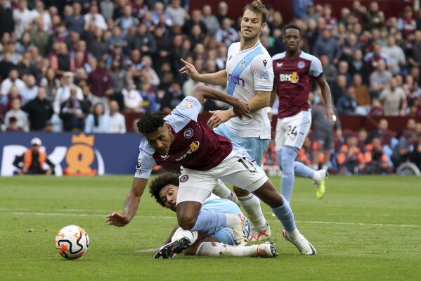 Aston Villa's Ollie Watkins, front, is fouled by Crystal Palace's Chris Richards for a penalty during the English Premier League soccer match between Aston Villa and Crystal Palace at Villa Park, in Birmingham, England, Saturday, Sept. 16, 2023. (Barrington Coombs/PA via AP)