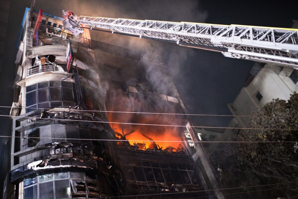 Firefighters work to contain a fire that broke out at a commercial complex in Dhaka, Bangladesh, Thursday, Feb. 29, 2024. Bangladesh's health minister says a fire in a six-story commercial complex in the nation's capital, Dhaka, has killed several people and injured dozens of others. (AP Photo/Mahmud Hossain Opu)