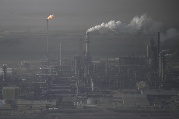Steam rises at Suncor's oil sands facility near Fort McMurray, Canada, on Friday, Sep. 1, 2023. Wildfires are bringing fresh scrutiny to Canada's fossil fuel dominance, its environmentally friendly image and the viability of becoming carbon neutral by 2050.(AP Photo/Victor R. Caivano)
