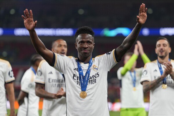 Real Madrid's Vinicius Junior waves after winning the Champions League final soccer match between Borussia Dortmund and Real Madrid at Wembley stadium in London, Saturday, June 1, 2024. (AP Photo/Kirsty Wigglesworth)