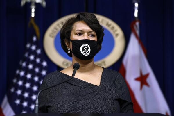 FILE - District of Columbia Mayor Muriel Bowser wears a face mask, as she speaks at a news conference on the coronavirus and the District's response, July 13, 2020, in Washington. The nation’s capital is reinstating its indoor mask mandate as the region and country grapple with a fresh surge in COVID-19 infections. (AP Photo/Patrick Semansky, File)