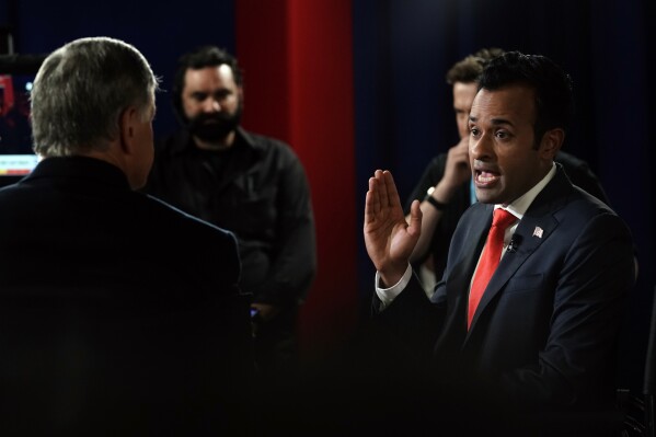 Businessman Vivek Ramaswamy talks with Sean Hannity in the spin room after a Republican presidential primary debate hosted by FOX News Channel Wednesday, Aug. 23, 2023, in Milwaukee. (AP Photo/Morry Gash)