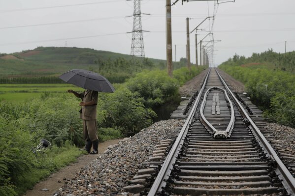 
              In this Friday, July 21, 2017, photo, a man stands near the pathway leading to where an unexploded bomb was found near the railway which runs through Hamhung from Pyongyang to the northeastern port of Chongjin. North Korea is just one of many countries still dealing with the explosive legacy of major wars. But the three-year Korean War, which ended in what was supposed to be a temporary armistice on July 27, 1953, was one of the most brutal ever fought. (AP Photo/Wong Maye-E)
            