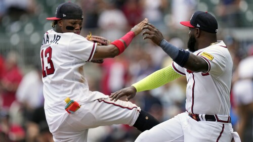 Atlanta Braves' Ronald Acuna Jr. (13), left, and Marcell Ozuna celebrate after defeating the Arizona Diamondbacks in a baseball game Thursday, July 20, 2023, in Atlanta. (AP Photo/John Bazemore)