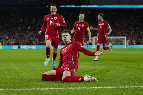 FILE - Wales' Neco Williams, foreground, celebrates after scoring his team second goal during the UEFA European Championship play-off match against Finland at the Cardiff City Stadium in Cardiff, Wales, Thursday, March 21, 2024. The post-Gareth Bale era looked particularly daunting for Wales. A principality with a population of 3 million needed to replace its best ever player, a Real Madrid great, once the most expensive signing in soccer history. But the Welsh maybe needn’t have worried because they are on the brink of qualifying for another major tournament. (AP Photo/Alastair Grant, File)