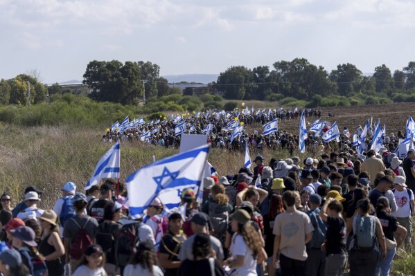 FILE - Families and friends of about 240 hostages held by Hamas in Gaza call for their return as they participate in a five-day "March for the Hostages" from Tel Aviv to the Prime Minister's Office in Jerusalem, near the village of Beit Hashmonai, Israel on Nov. 16, 2023. (AP Photo/Ohad Zwigenberg, File)