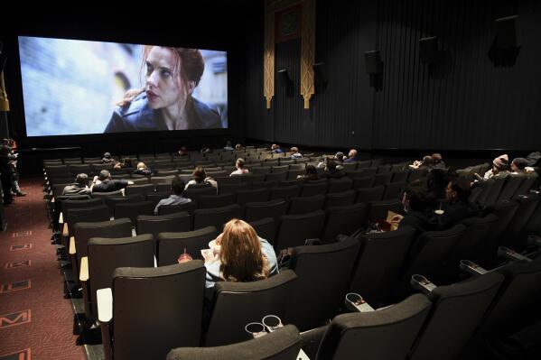 FILE - Moviegoers sit in a socially distant seating arrangement at the AMC Lincoln Square 13 theater on the first day of reopened theaters in New York on March 5, 2021. After more than a year of uncertainty and ever-fluctuating release schedules, there will be a summer movie season. The blockbusters are back. (Photo by Evan Agostini/Invision/AP, File)