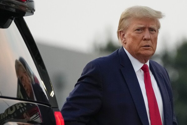 Former President Donald Trump walks to speak with reporters before departure from Hartsfield-Jackson Atlanta International Airport, Thursday, Aug. 24, 2023, in Atlanta. (AP Photo/Alex Brandon)