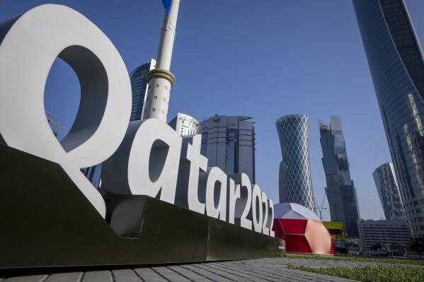 FILE - Branding is displayed near the Doha Exhibition and Convention Center in Doha, Qatar, Thursday, March 31, 2022. Qatar’s ruling emir has lashed out at criticism of the country over its hosting of the 2022 FIFA World Cup, complaining of an “unprecedented campaign” targeting the first Arab nation to hold the tournament. (AP Photo/Darko Bandic, File)