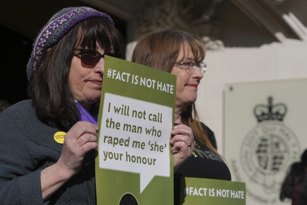 Women's rights activists hold placards outside the Supreme Court to challenge gender recognition laws, in London, Wednesday, April 16, 2025. (AP Photo/Kin Cheung)