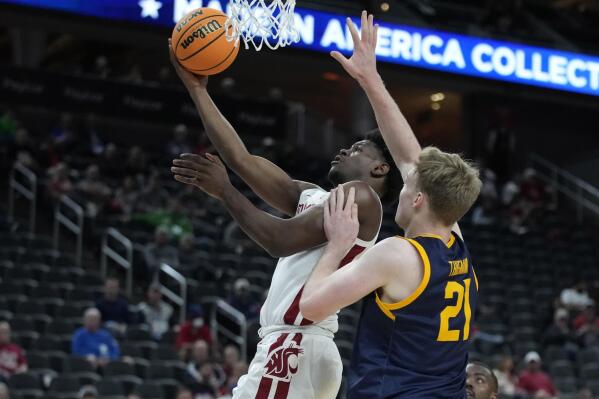 FILE - Washington State's TJ Bamba (5) shoots around California's Lars Thiemann (21) during the first half of an NCAA college basketball game in the first round of the Pac-12 tournament Wednesday, March 9, 2022, in Las Vegas. Bamba averaged 7.7 points and 3.4 rebounds per game last year. (AP Photo/John Loche, File)