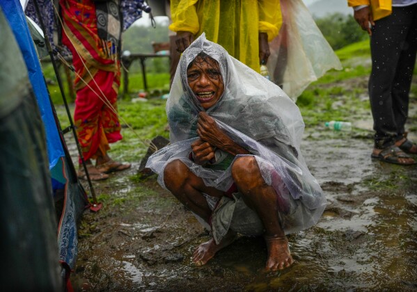 A woman whose family members are trapped under rubble wails after a landslide washed away houses in Raigad district, western Maharashtra state, India, Thursday, July 20, 2023. (AP Photo/Rafiq Maqbool)