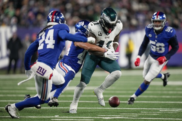 New York Giants cornerback Nick McCloud (44) forces a fumble on Philadelphia Eagles wide receiver A.J. Brown (11) during the first quarter of an NFL football game, Sunday, Jan. 7, 2024, in East Rutherford, N.J. (AP Photo/Seth Wenig)