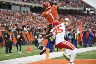 Cincinnati Bengals wide receiver Ja'Marr Chase (1) catches a pass for an 18-yard touchdown as Kansas City Chiefs cornerback Charvarius Ward (35) defends during the first half of an NFL football game, Sunday, Jan. 2, 2022, in Cincinnati. (AP Photo/David Dermer)