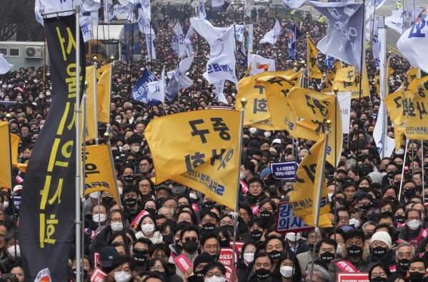 Doctors stage a rally against the government's medical policy in Seoul, South Korea, Sunday, March 3, 2024. South Korean officials said Tuesday they are seeking to get the leaders of thousands of striking junior doctors to face police investigations as part of legal repercussions for their walkouts that have disrupted hospital operations. (AP Photo/Ahn Young-joon)