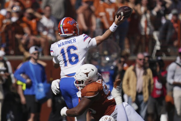 Florida quarterback Aidan Warner (16) is hit by Texas defensive lineman Alfred Collins (95) as he throws during the first half of an NCAA college football game in Austin, Texas, Saturday, Nov. 9, 2024. (AP Photo/Eric Gay)