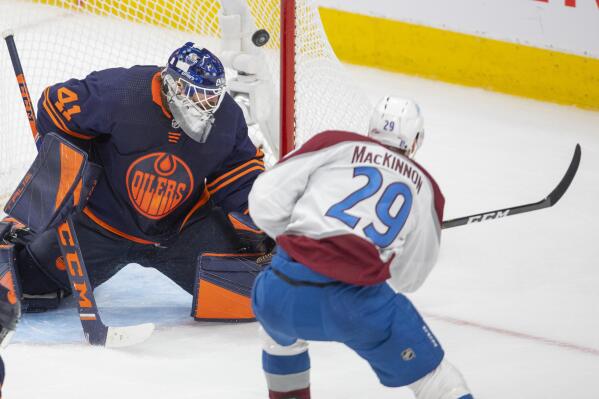 Colorado Avalanche's Nathan MacKinnon (29) scores on Edmonton Oilers goalie Mike Smith (41) during third period NHL playoff hockey action in Edmonton, Alberta, Monday, June 6, 2022. (Amber Bracken/The Canadian Press via AP)