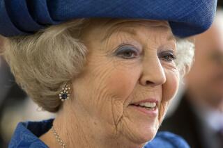 FILE - Dutch Queen Beatrix smiles when touring a museum in the Netherlands, in this Monday April 8, 2013 file photo. Princess Beatrix, the 83-year-old former Dutch queen, has tested positive for the coronavirus, the royal house announced Saturday. (AP Photo/Peter Dejong, File).