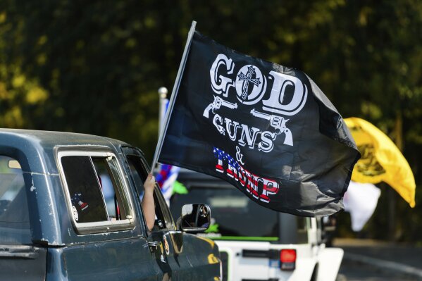 FILE - This Sept. 7, 2020 file photo shows the "Oregon for Trump 2020 Labor Day Cruise Rally"  at Clackamas Community College in Oregon City, Ore.  Gun ownership is a question that has dogged Christians for years, but conservative Christians are increasingly answering “yes.” (AP Photo/Michael Arellano)
