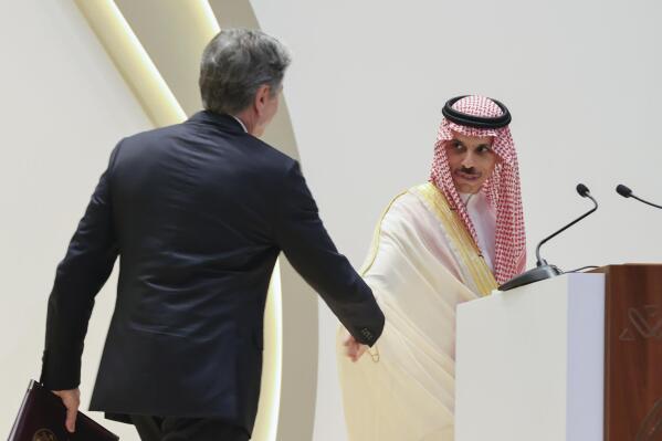 Secretary of State Antony Blinken shakes hands with Saudi Arabia's Foreign Minister Prince Faisal bin Farhan during a joint news conference at the Intercontinental Hotel in Riyadh, Saudi Arabia, Thursday, June 8, 2023. (Ahmed Yosri/Pool Photo via AP)