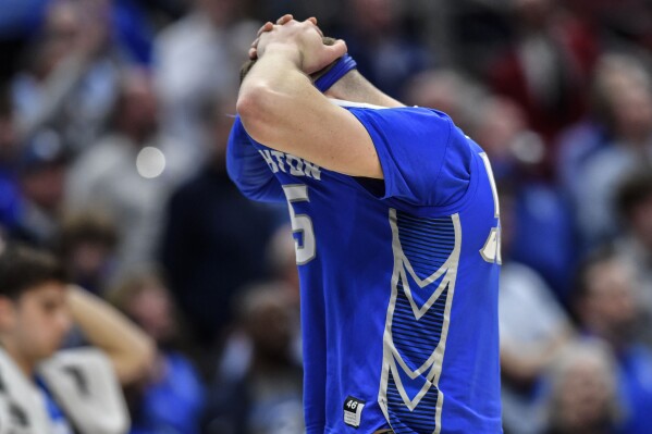 FILE - Creighton guard Baylor Scheierman (55) reacts to losing to San Diego State after a Elite 8 college basketball game in the South Regional of the NCAA Tournament, Sunday, March 26, 2023, in Louisville, Ky. San Diego State won 57-56. Hands on his head with the front of his jersey pulled up to cover his face, Baylor Scheierman was the picture of Creighton's raw emotion in the immediate aftermath of its crushing loss in the NCAA Elite last year. That loss to San Diego State denied the Bluejays of their first Final Four and made Scheierman's decision to come back to college for a fifth year a lot easier.(AP Photo/Timothy D. Easley, File)