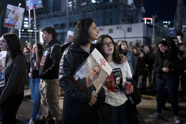Women listen to a speaker during a weekly rally calling for the release of hostages who were kidnapped on Oct. 7, 2023, in Tel Aviv, Israel, Saturday, Feb. 3, 2024. (AP Photo/Maya Alleruzzo)