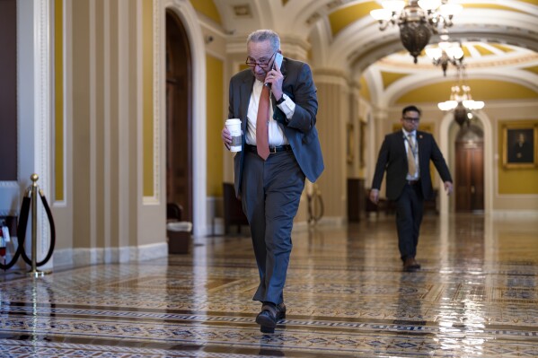 Senate Majority Leader Chuck Schumer, D-N.Y., arrives at the Capitol while Republicans hold a closed-door meeting after blocking a bipartisan border package that had been tied to wartime aid for Ukraine, at the Capitol in Washington, Thursday, Feb. 8, 2024. (AP Photo/J. Scott Applewhite)