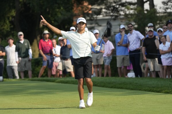 Charlie Woods signals after hitting off the 18th tee during the second round of stroke play of the U.S. Junior Amateur Golf Championship, Tuesday, July 23, 2024, in Bloomfield Township, Mich. (ĢӰԺ Photo/Carlos Osorio)