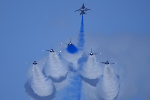 The South Korean Air Force's Black Eagles aerobatic team performs during the first day of the Singapore Airshow in Singapore, Tuesday, Feb. 20, 2024. (AP Photo/Vincent Thian)