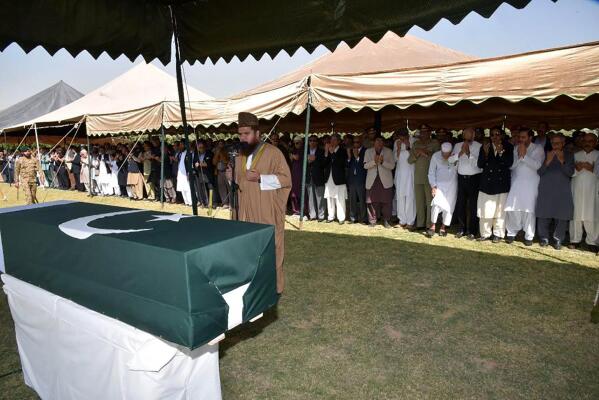 In this photo released by Inter Services Public Relations, military officials and others attend funeral prayer of Pakistan's former President Pervez Musharraf, in Karachi, Pakistan, Tuesday, Feb. 7, 2023. Musharraf was buried Tuesday in his family's hometown, the southern port city of Karachi, a day after a special plane transported his body from the United Arab Emirates where he died on the weekend. (Inter Services Public Relations via AP)