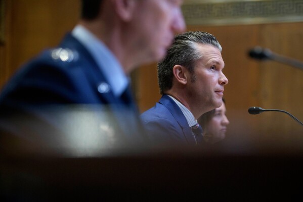 Secretary of Defense Pete Hegseth, right, and Gen. John D. Caine, chairman of the Joint Chiefs of Staff, left, appear before a Senate Committee on Appropriations subcommittee hearing to examine proposed budget estimates for fiscal year 2026 for the Department of Defense, on Capitol Hill, Wednesday, June 11, 2025, in Washington. (AP Photo/Rod Lamkey, Jr.)