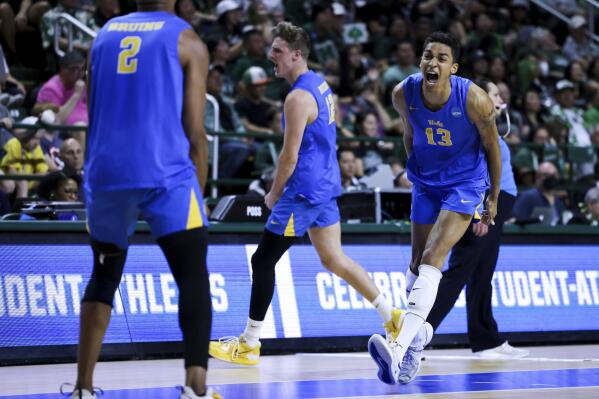 UCLA middle blocker Merrick McHenry (13), middle blocker J.R. Norris IV (2) and outside hitter Alex Knight (12) react during a match against Hawaii in the NCAA college men's volleyball tournament, Saturday, May 6, 2023, in Fairfax, Va. (Julia Nikhinson/Honolulu Star-Advertiser via AP)