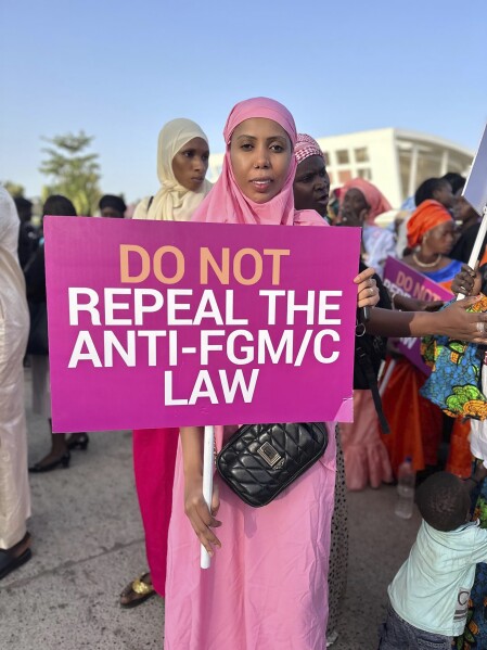 Jaha Dukureh, the founder of Safe Hands for Girls, pickets outside parliament in Serrekunda, Gambia, Monday, March 18, 2024. The West African nation of Gambia could become the first country in the world to reverse a ban on female genital cutting, a practice that experts say is dangerous and has no benefits. Lawmakers are voting Monday on legislation that seeks to repeal the 2015 ban. (Hadim Thomas-Safe Hands for Girls via AP)