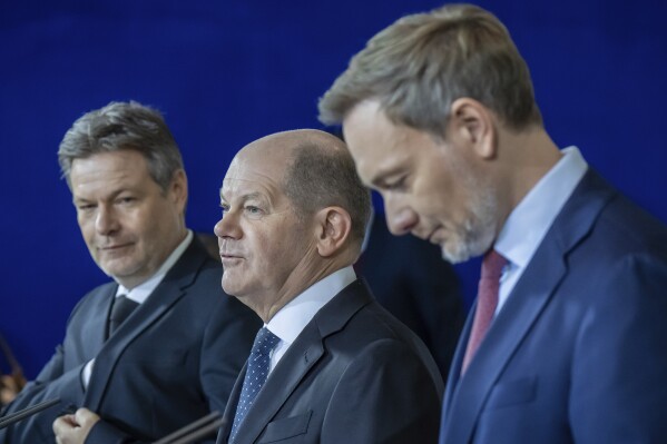 From left, Robert Habeck, Federal Minister for Economic Affairs and Climate Protection, Federal Chancellor Olaf Scholz and Christian Lindner, Federal Minister of Finance, give a press statement on the agreement for the 2024 federal budget in the Federal Chancellery, in Berlin, Wednesday, Dec. 13, 2023. The German government on Wednesday reached a solution to a budget crisis triggered by a court ruling last month, German news agency dpa reported. (Michael Kappeler/dpa via AP)