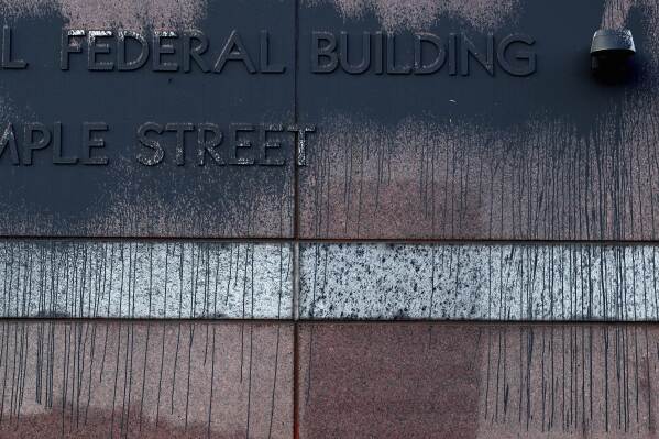 Spray paint remains on the Edward R. Roybal Federal Building Tuesday, June 17, 2025, in Los Angeles. (AP Photo/Wally Skalij)