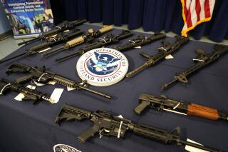 FILE - Firearms are displayed during a news conference at the Miami Field Office of the Homeland Security Investigations (HSI), that was working with other agencies to crack down on an increase of firearms and ammunition smuggling to Haiti and other Caribbean nations, on Aug. 17, 2022. Increasingly sophisticated weapons are being trafficked into Haiti mainly from the United States and especially from Florida amid worsening lawlessness in the impoverished Caribbean nation, according to a U.N. report released Friday, March 4, 2023. (AP Photo/Lynne Sladky, File)