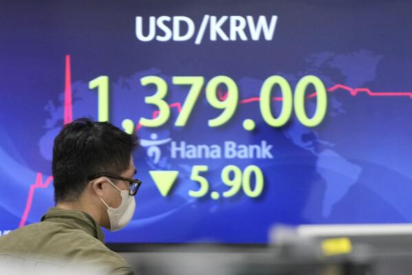 A currency trader walks near the screen showing the foreign exchange rate between U.S. dollar and South Korean won at a foreign exchange dealing room in Seoul, South Korea, Wednesday, Nov. 9, 2022. Asian shares were mixed on Wednesday as investors awaited the outcome of the U.S. midterm elections and a major inflation update due later in the week. (AP Photo/Lee Jin-man)