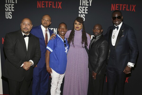 FILE- In this May 20, 2019 file photo, Director Ava DuVernay, center, with the Central Park 5: Raymond Santana, from left, Kevin Richardson, Korey Wise, Anthony McCray and Yuesf Salaam, attend the world premiere of 